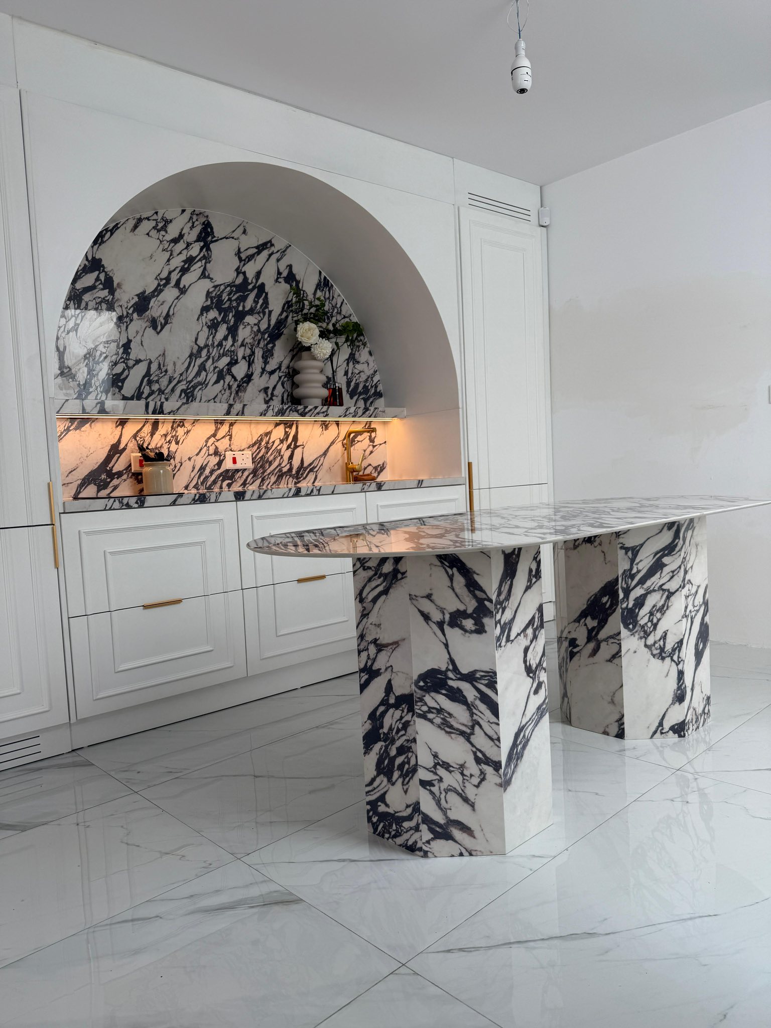 A refined interior installation showcasing marble surfaces and bespoke detailing.